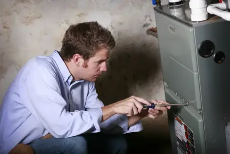 A tech repairing a furnace